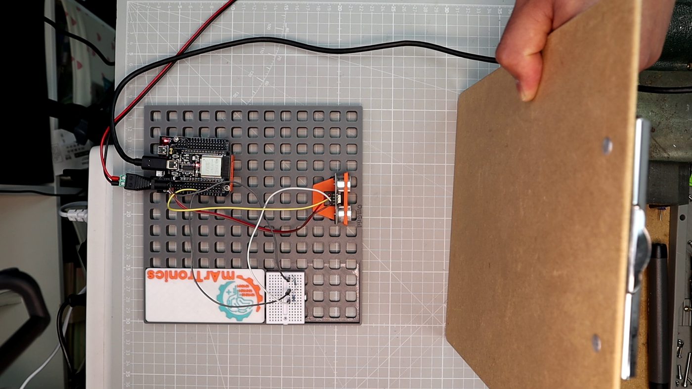 A wooden board held at an angle in front of the HC-SR04 on the OmGrid, the case where the echo scatters away