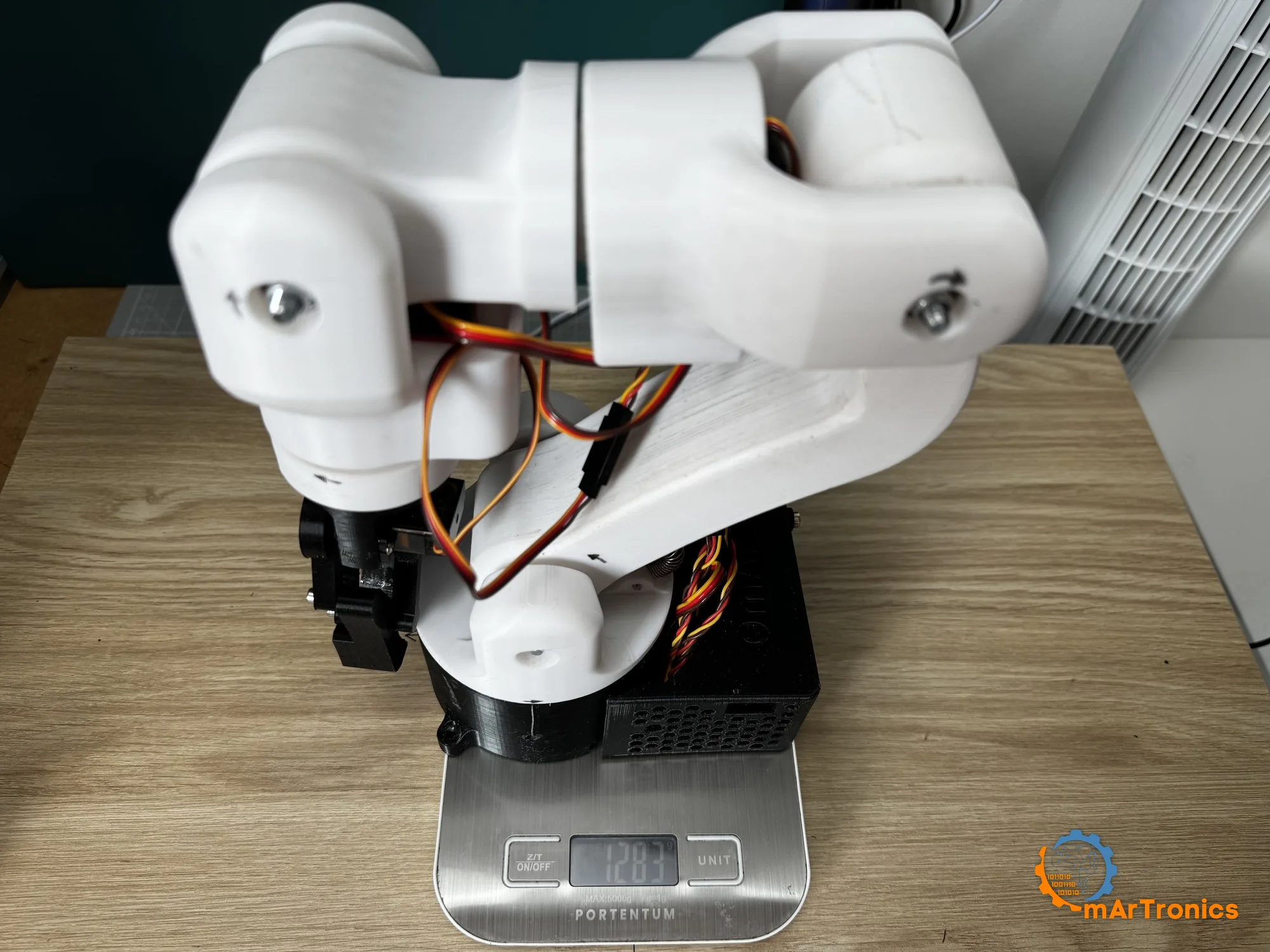 The assembled arm standing on a kitchen scale
